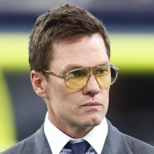 Former NFL quarterback Tom Brady looks on from the sideline before the game between the Philadelphia Eagles and Dallas Cowboys at AT&T Stadium.
