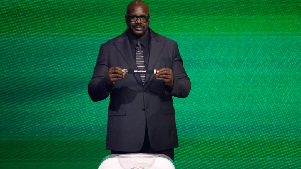 Dec 5, 2025; Washington, District of Columbia, USA; Shaquille O'Neal draws the card of Senegal for Group I during the FIFA World Cup 2026 Final Draw at John F. Kennedy Center for the Performing Arts