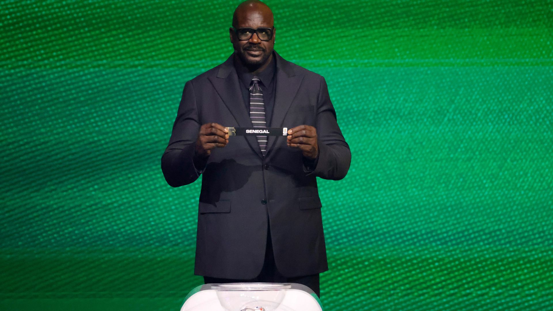 Dec 5, 2025; Washington, District of Columbia, USA; Shaquille O'Neal draws the card of Senegal for Group I during the FIFA World Cup 2026 Final Draw at John F. Kennedy Center for the Performing Arts
