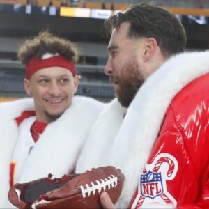 Kansas City Chiefs quarterback Patrick Mahomes (middle) and tight end Travis Kelce (right) open their Netflix Christmas GameDay cake gifts after the Chiefs defeated the Pittsburgh Steelers at Acrisure Stadium.