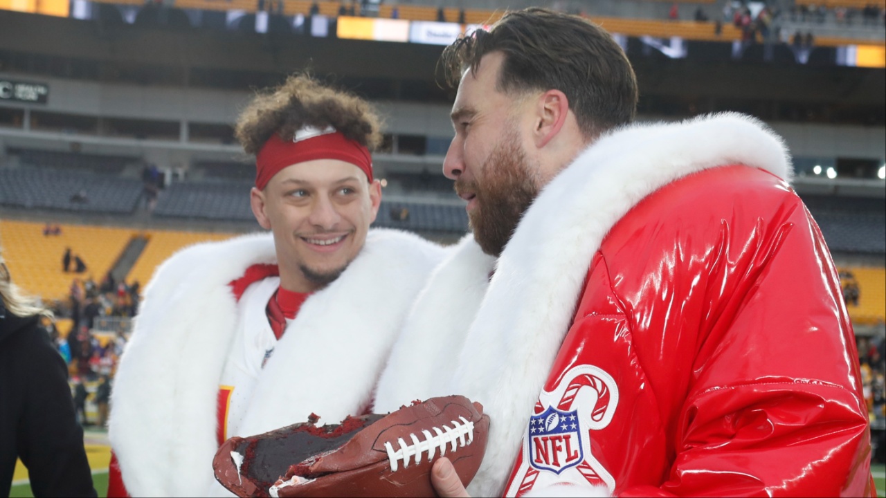 Kansas City Chiefs quarterback Patrick Mahomes (middle) and tight end Travis Kelce (right) open their Netflix Christmas GameDay cake gifts after the Chiefs defeated the Pittsburgh Steelers at Acrisure Stadium.