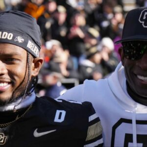 Colorado Buffaloes safety Shilo Sanders (21) and head coach Deion Sanders and quarterback Shedeur Sanders (2) and social media producer Deion Sanders Jr. following the win against the Oklahoma State Cowboys at Folsom Field.