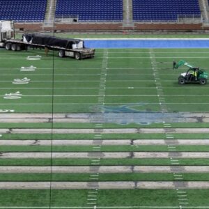 Work begins on the field at Ford Field in Detroit on Thursday, Jan. 26, 2023. The Lions are making the switch from a slit-film turf to a monofilament field turf, which is the most grass-like surface of the turf that is used in NFL stadiums. Fordfield 012623 Es02