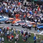 Feb 16, 2025; Daytona Beach, Florida, USA; NASCAR fans participate in pre race activities on pit row before the Daytona 500 at Daytona International Speedway.