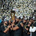 Dec 16, 2025; Las Vegas, Nevada, USA; New York Knicks center/forward Karl-Anthony Towns (32) and guard Jalen Brunson (11) hold the the Emirates NBA Cup trophy after victory over the San Antonio Spurs at T-Mobile Arena. Mandatory Credit: Kirby Lee-Imagn Images