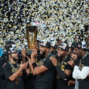 Dec 16, 2025; Las Vegas, Nevada, USA; New York Knicks center/forward Karl-Anthony Towns (32) and guard Jalen Brunson (11) hold the the Emirates NBA Cup trophy after victory over the San Antonio Spurs at T-Mobile Arena. Mandatory Credit: Kirby Lee-Imagn Images