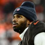Cleveland Browns quarterback Shedeur Sanders (12) watches from the sidelines late in the fourth quarter against the Tennessee Titans at Huntington Bank Field.
