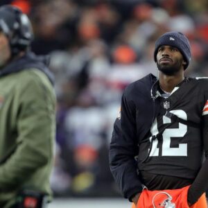 Cleveland Browns quarterback Shedeur Sanders (12) waits for his opportunity as head coach Kevin Stefanski watches Dillon Gabriel lead the offense during the first half of an NFL football game at Huntington Bank Field, Nov. 16, 2025, in Cleveland, Ohio.