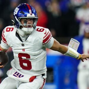 New York Giants quarterback Jaxson Dart (6) runs with the ball during the second quarter against the New England Patriots at Gillette Stadium.