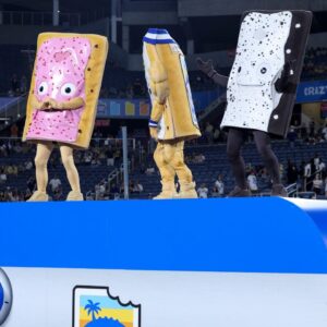 Pop-Tarts mascots celebrate with BYU Cougars after beating Georgia Tech Yellow Jackets in the Pop-Tarts Bowl at Camping World Stadium.