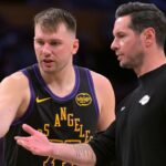Los Angeles Lakers guard Luka Doncic (77) talks with head coach JJ Redick during a time out in the second half against the Memphis Grizzlies at Crypto.com Arena.