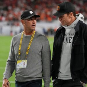 Egon Durban walks on the sideline with Tom Brady before the CFP National Championship college football game between the Indiana Hoosiers and the Miami Hurricanes at Hard Rock Stadium.