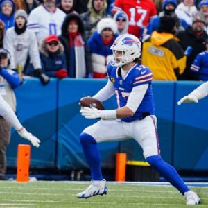 Buffalo Bills quarterback Josh Allen (17) scrambles avoiding Denver Broncos linebacker Cody Barton (55) and Denver Broncos linebacker Jonathon Cooper (0) and funs for a few yards before sliding down during the second half of the Buffalo Bills wild card game against the Denver Broncos at Highmark Stadium in Orchard Park on Jan. 12, 2025.