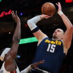 Denver Nuggets center Nikola Jokic (15) shoots the basketball over Miami Heat center Bam Adebayo (13) during the first quarter at Kaseya Center