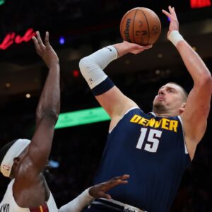 Denver Nuggets center Nikola Jokic (15) shoots the basketball over Miami Heat center Bam Adebayo (13) during the first quarter at Kaseya Center