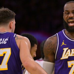 Nov 25, 2025; Los Angeles, California, USA; Los Angeles Lakers guard Luka Doncic (77) and forward LeBron James (23) react after a foul during the first half against the Los Angeles Clippers at Crypto.com Arena