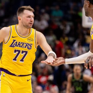 Jan 6, 2026; New Orleans, Louisiana, USA; Los Angeles Lakers forward/guard Luka Doncic (77) slaps hands with center Deandre Ayton (5) after a play against the New Orleans Pelicans during the second half at Smoothie King Center.