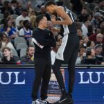 Dec 31, 2025; San Antonio, Texas, USA; San Antonio Spurs head coach Mitch Johnson talks with forward Victor Wembanyama (1) in the second half against the New York Knicks at Frost Bank Center