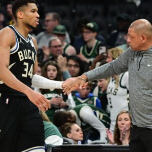 Apr 27, 2025; Milwaukee, Wisconsin, USA; Milwaukee Bucks forward Giannis Antetokounmpo (34) exits the game in the fourth quarter as head coach Doc Rivers shakes his hand during game four against the Indiana Pacers of first round for the 2024 NBA Playoffs at Fiserv Forum.