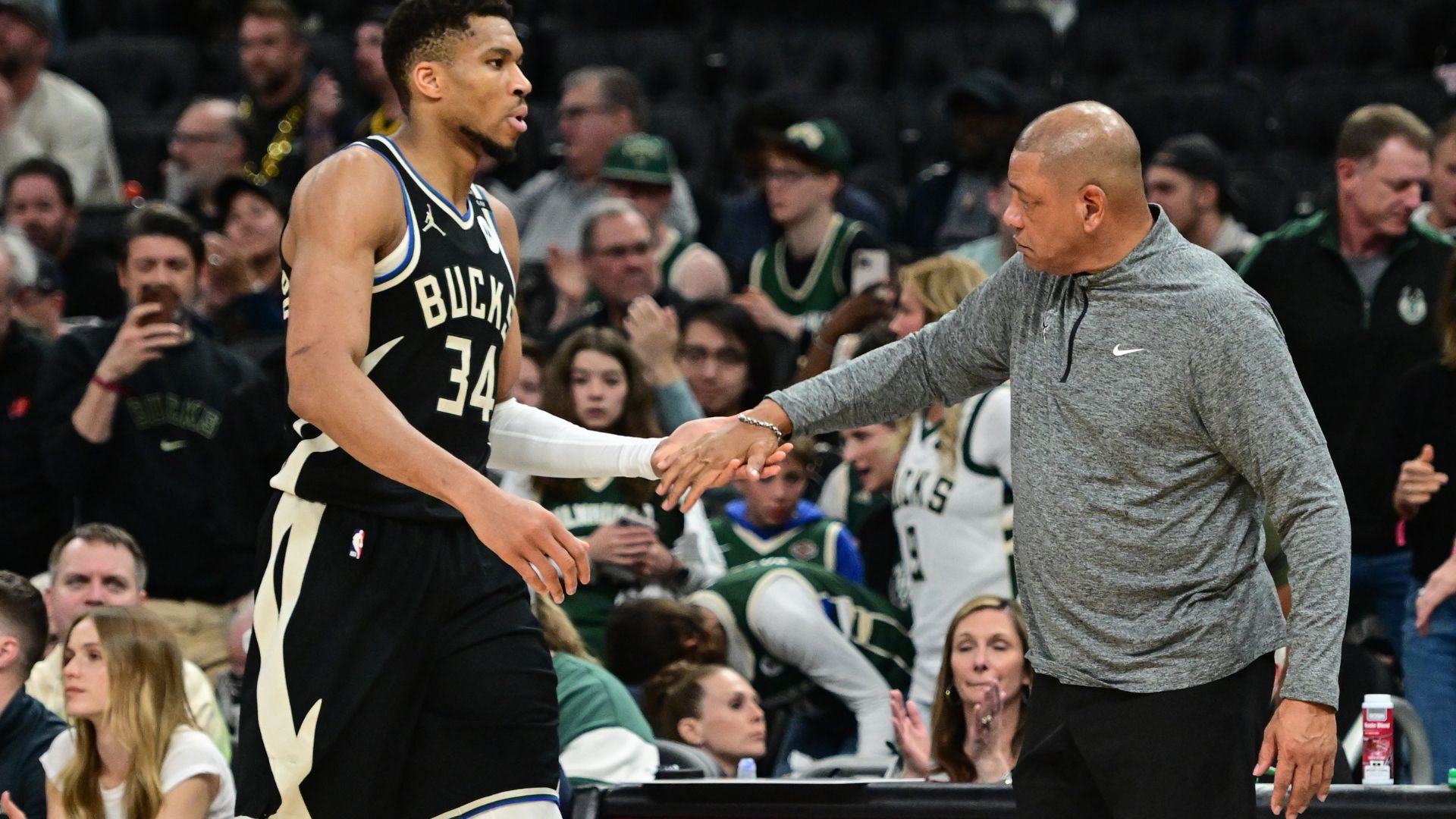 Apr 27, 2025; Milwaukee, Wisconsin, USA; Milwaukee Bucks forward Giannis Antetokounmpo (34) exits the game in the fourth quarter as head coach Doc Rivers shakes his hand during game four against the Indiana Pacers of first round for the 2024 NBA Playoffs at Fiserv Forum.