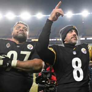 Pittsburgh Steelers quarterback Aaron Rodgers (8) and defensive tackle Cameron Heyward (97) celebrate after defeating the Baltimore Ravens at Acrisure Stadium.