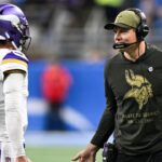 Minnesota Vikings head coach Kevin O'Connell greets quarterback J.J. McCarthy (9) after throwing a touchdown pass in the first quarter at Ford Field.
