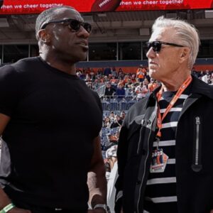 Former Denver Broncos player Shannon Sharpe (L) talks with the Broncos Director of Football Operations, John Elway (C) and former quarterback Peyton Manning (R) before the game against the New York Jets at Empower Field at Mile High.