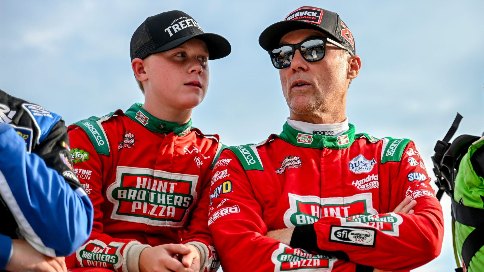 Former NASCAR Cup Series champion Kevin Harvick, center, right, and his son Keelan, 13, look on before the two raced in the 13th annual Masters of the Pros 200 race on Wednesday, July 16, 2025, at the Owosso Speedway.