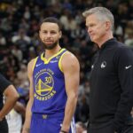 Golden State Warriors guard Stephen Curry (30) and head coach Steve Kerr talk on the sideline during the first quarter against the Utah Jazz at Delta Center.