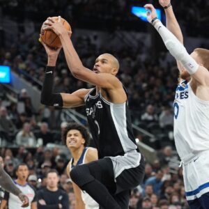 Jan 17, 2026; San Antonio, Texas, USA; San Antonio Spurs forward Victor Wembanyama (1) goes up for a shot in front of Minnesota Timberwolves guard Donte DiVincenzo (0) in the second half at Frost Bank Center