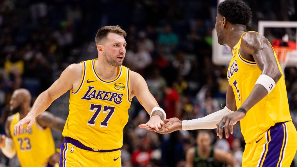 Jan 6, 2026; New Orleans, Louisiana, USA; Los Angeles Lakers forward/guard Luka Doncic (77) slaps hands with center Deandre Ayton (5) after a play against the New Orleans Pelicans during the second half at Smoothie King Center.