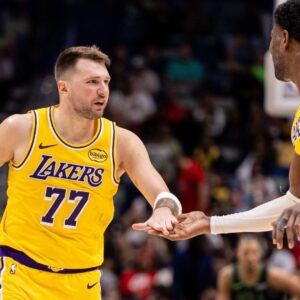 Jan 6, 2026; New Orleans, Louisiana, USA; Los Angeles Lakers forward/guard Luka Doncic (77) slaps hands with center Deandre Ayton (5) after a play against the New Orleans Pelicans during the second half at Smoothie King Center.