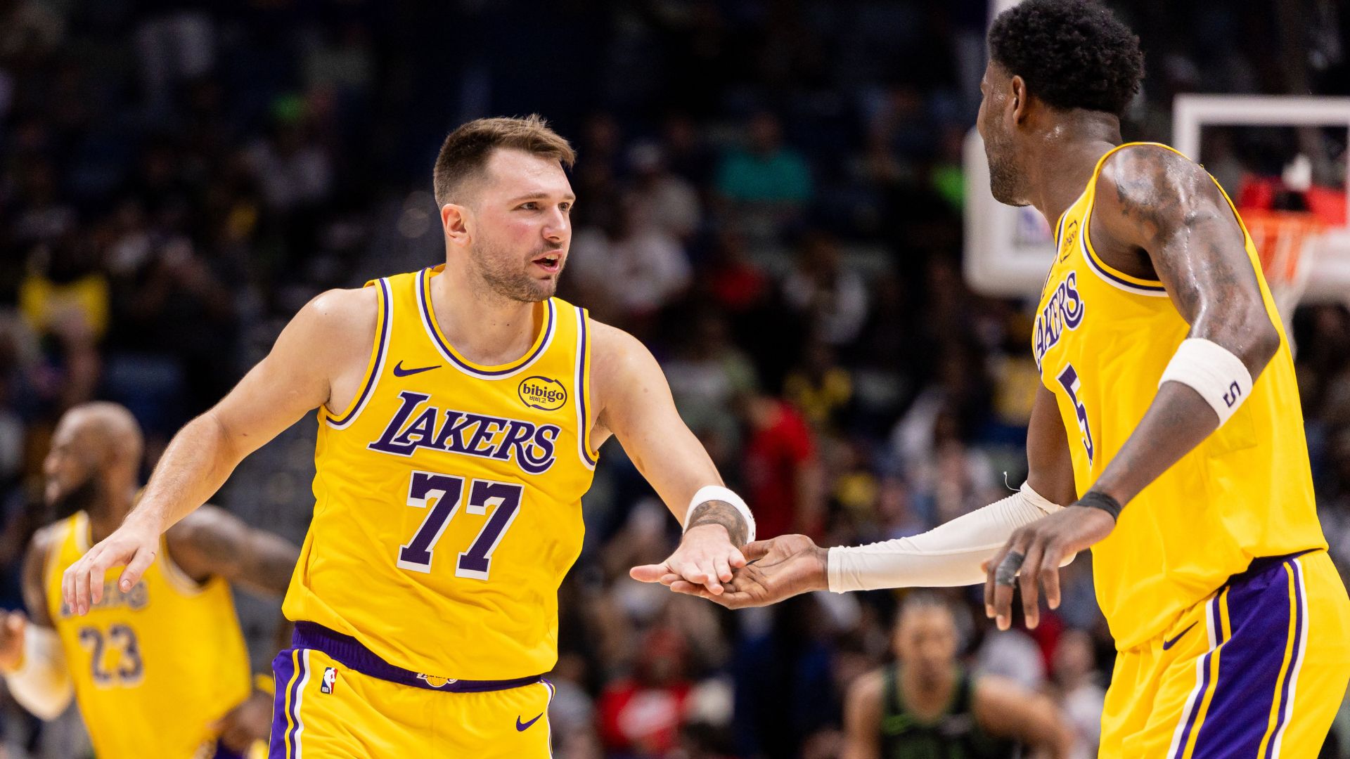 Jan 6, 2026; New Orleans, Louisiana, USA; Los Angeles Lakers forward/guard Luka Doncic (77) slaps hands with center Deandre Ayton (5) after a play against the New Orleans Pelicans during the second half at Smoothie King Center.