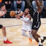New York Knicks guard Jalen Brunson (11) looks to drive past Brooklyn Nets forward Noah Clowney (21) and guard Egor Demin (8) in the first quarter at Madison Square Garden