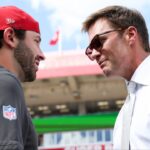 Tampa Bay Buccaneers quarterback Baker Mayfield (6), left, speaks with Tom Brady before the game against the Philadelphia Eagles at Raymond James Stadium.