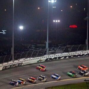 Feb 14, 2021; Daytona Beach, Florida, USA; NASCAR Cup Series driver Denny Hamlin (11) leads the field in turn four during the Daytona 500 at Daytona International Speedway.