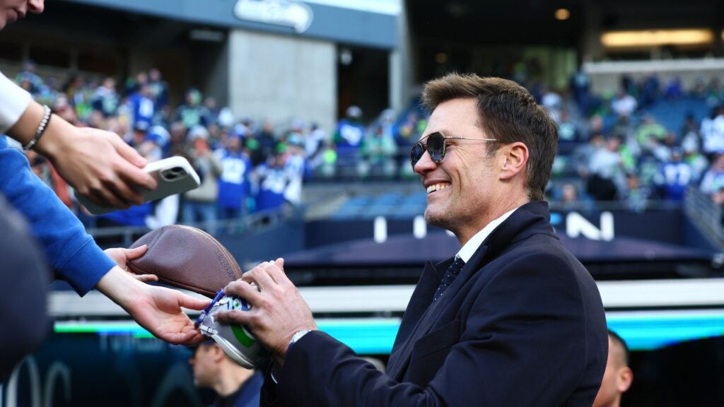 Tom Brady signs autographs before the 2026 NFC Championship Game between the Seattle Seahawks and the Los Angeles Rams at Lumen Field.