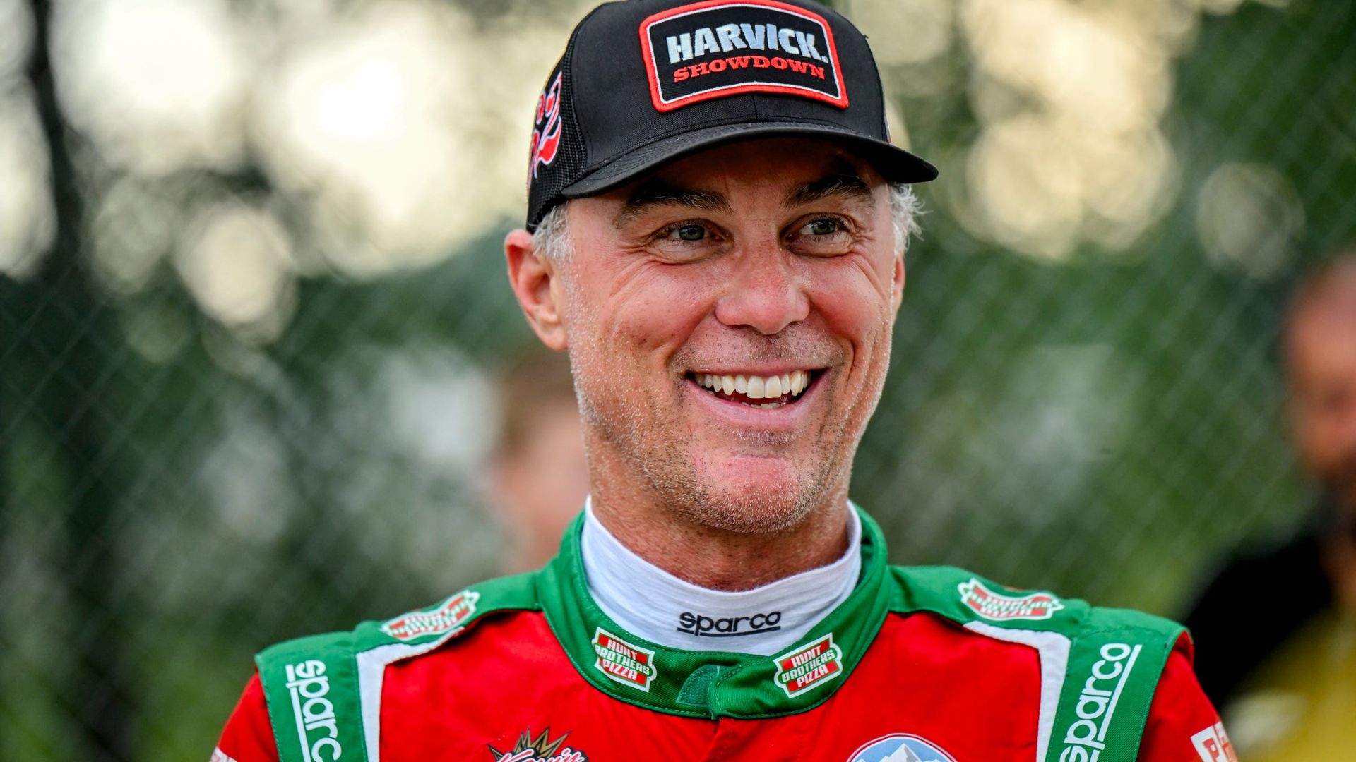 Former NASCAR Cup Series champion Kevin Harvick smiles during an autograph session before the 13th annual Masters of the Pros 200 race on Wednesday, July 16, 2025, at the Owosso Speedway.