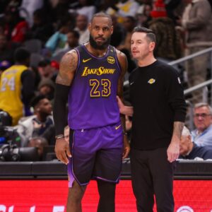 Dec 6, 2024; Atlanta, Georgia, USA; Los Angeles Lakers forward LeBron James (23) talks to head coach JJ Redick against the Atlanta Hawks in the second quarter at State Farm Arena