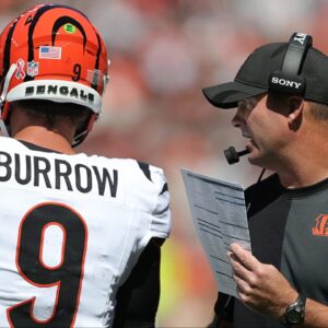 Cincinnati Bengals head coach Zac Taylor, right, has a word with quarterback Joe Burrow (9) during the first half of an NFL football game at Huntington Bank Field, Sept. 7, 2025, in Cleveland, Ohio.