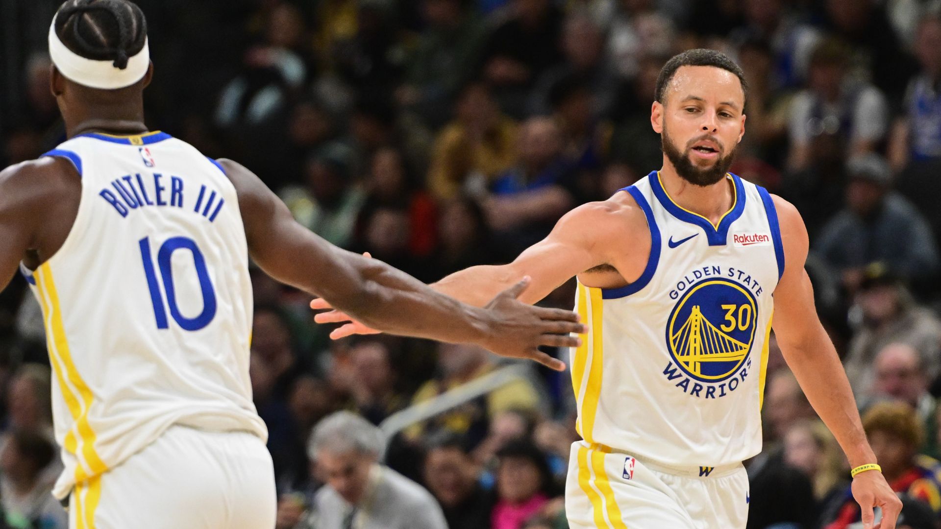 Oct 30, 2025; Milwaukee, Wisconsin, USA; Golden State Warriors guard Stephen Curry (30) reacts with forward Jimmy Butler (10) after scoring a basket in the 3rd quarter against the Milwaukee Bucks