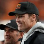 Tom Brady looks on from the sideline before the CFP National Championship college football game between the Indiana Hoosiers and the Miami Hurricanes at Hard Rock Stadium.