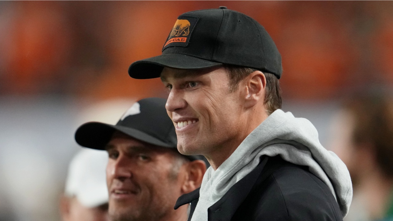 Tom Brady looks on from the sideline before the CFP National Championship college football game between the Indiana Hoosiers and the Miami Hurricanes at Hard Rock Stadium.