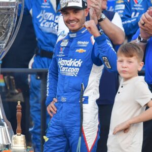 Nov 2, 2025; Avondale, Arizona, USA; NASCAR Cup Series driver Kyle Larson (5) celebrates his championship victory following the Cup Series Championship race with son Owen at Phoenix Raceway.