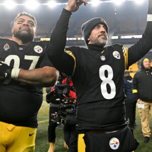 Pittsburgh Steelers quarterback Aaron Rodgers (8) and defensive tackle Cameron Heyward (97) celebrate after defeating the Baltimore Ravens at Acrisure Stadium.