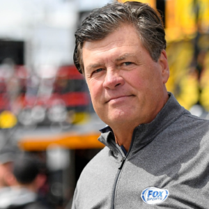 May 10, 2019; Kansas City, KS, USA; Philadelphia Phillies right fielder Andrew McCutchen (L) talks with Fox Sports analyst Michael Waltrip (R) during practice for the Digital Ally 400 at Kansas Speedway. Mandatory Credit: Jasen Vinlove-Imagn Images