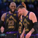Los Angeles Lakers forward LeBron James (23) and Los Angeles Lakers guard Luka Doncic (77) walk to the bench during a time out in the second half at Crypto.com Arena.