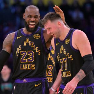 Los Angeles Lakers forward LeBron James (23) and Los Angeles Lakers guard Luka Doncic (77) walk to the bench during a time out in the second half at Crypto.com Arena.