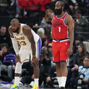 Dec 20, 2025; Inglewood, California, USA; Los Angeles Lakers forward Lebron James (23) and LA Clippers guard James Harden (1) react in the first half at Intuit Dome.