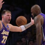 Dec 10, 2025; Los Angeles, California, USA; Los Angeles Lakers guard Luka Doncic (77) and forward Lebron James (23) react after a foul call during the second half against the San Antonio Spurs at Crypto.com Arena